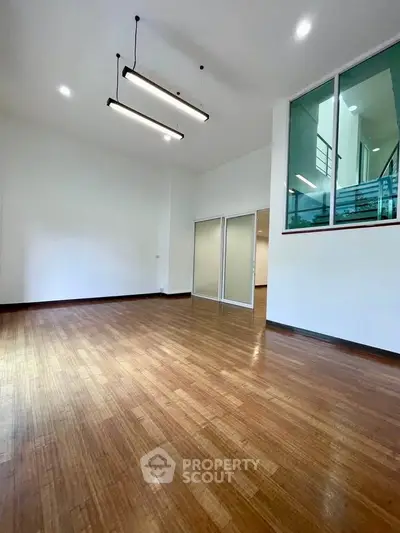 Spacious modern living room with high ceilings and wooden flooring
