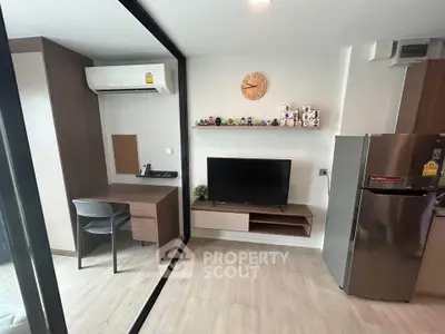Modern living room with sleek furniture and wall-mounted TV in a stylish apartment.