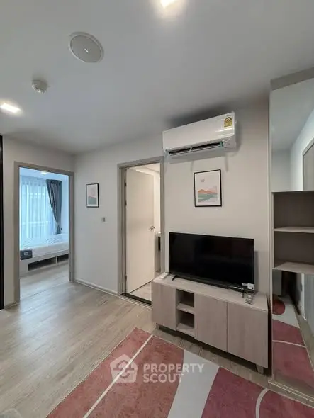 Modern living room with TV and air conditioning in a stylish apartment