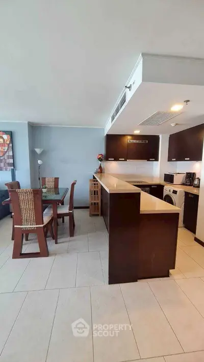 Modern open-layout kitchen with dining area and sleek appliances