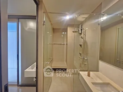 Modern bathroom with glass shower enclosure and sleek fixtures