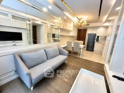 Luxurious living room with elegant dining area and modern kitchen in open layout apartment.