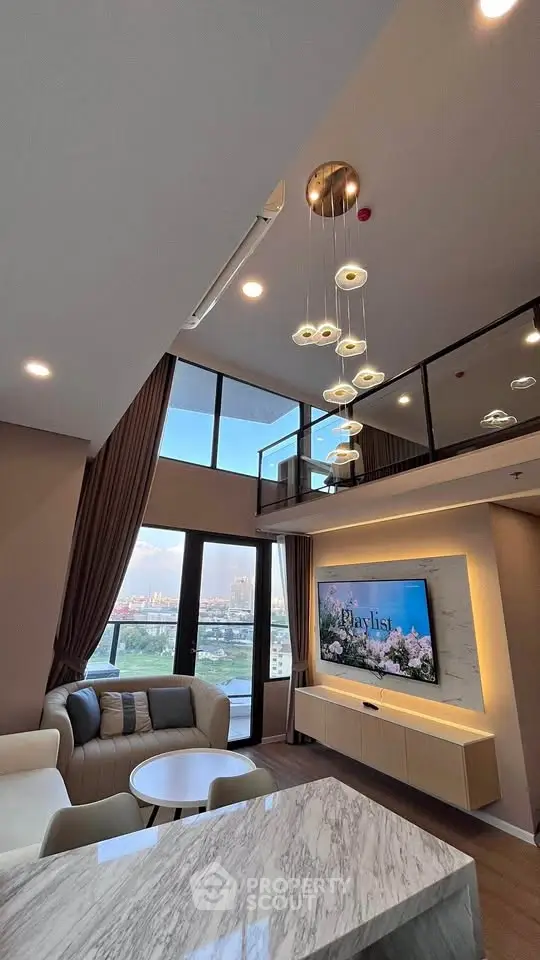 Luxurious modern living room with high ceiling and stunning city view from balcony.