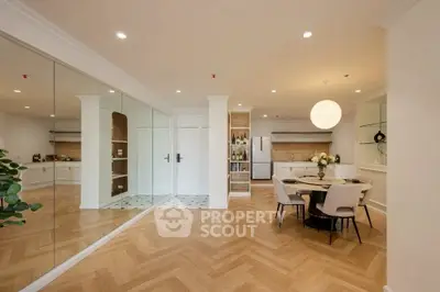Spacious modern living room with elegant dining area and mirrored wall