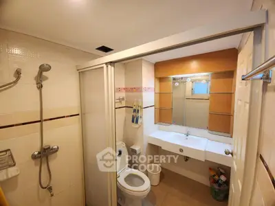 Spacious bathroom with modern fixtures and ample storage space.