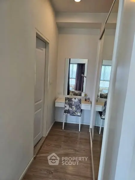 Chic small study nook with mirror and floral chair in modern apartment