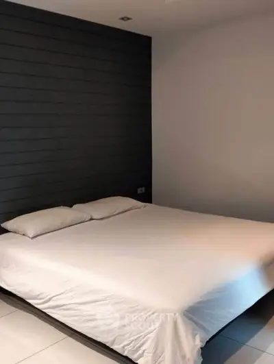 Modern minimalist bedroom with sleek design and cozy ambiance.