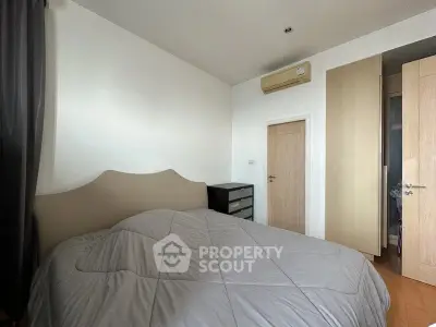 Cozy bedroom with modern furnishings and air conditioning in a stylish apartment.