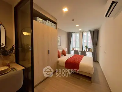 Modern bedroom with stylish decor and natural light, featuring a cozy bed and elegant furnishings.