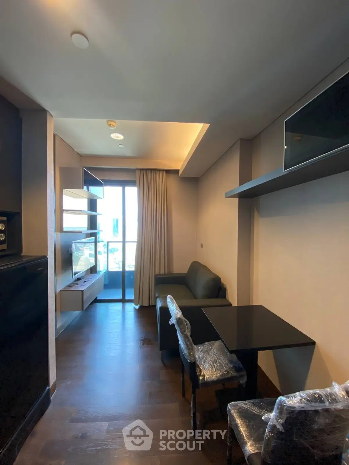 Modern living room with balcony access and sleek furniture design.