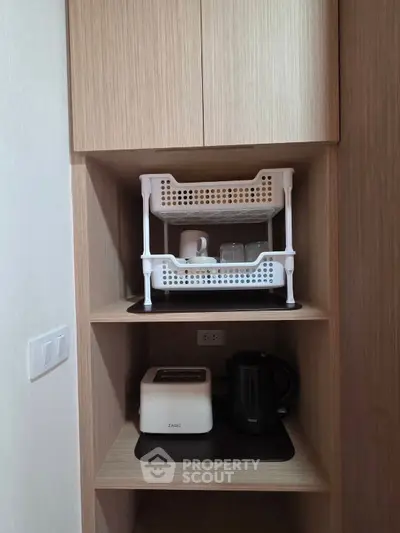 Compact kitchen storage with toaster and kettle in modern apartment