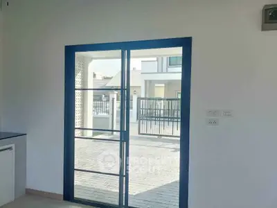 Modern interior view with sliding glass door leading to a stylish outdoor area in a contemporary home.