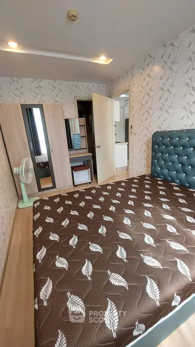 Cozy bedroom with stylish decor and ample storage space, featuring a comfortable bed and modern wardrobe.