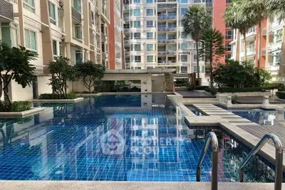 Luxurious residential complex with a stunning outdoor pool and modern architecture.