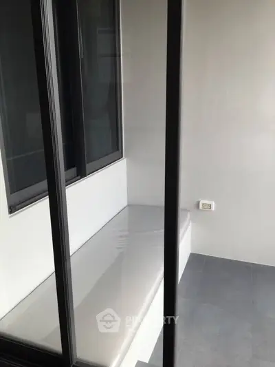 Modern minimalist balcony with sleek glass doors and clean lines