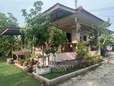 Charming single-story house with lush garden and spacious porch, perfect for outdoor relaxation.