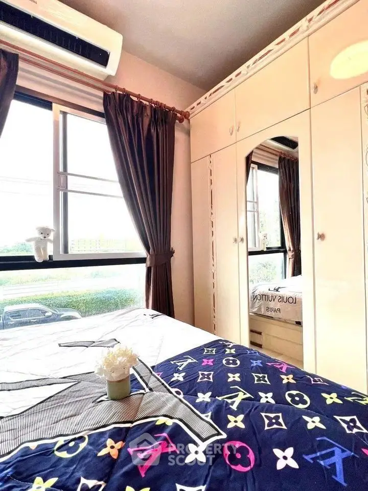 Cozy bedroom with mirrored wardrobe and large window view