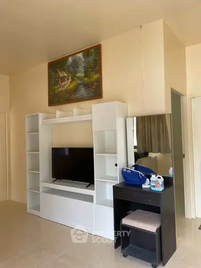 Cozy living room with modern entertainment center and wall art, perfect for relaxation.