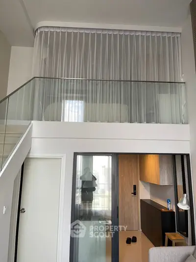 Modern loft apartment with glass railing and stylish interior design