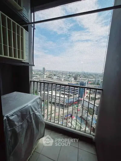 Stunning city view from a high-rise balcony with protective netting, perfect for urban living.