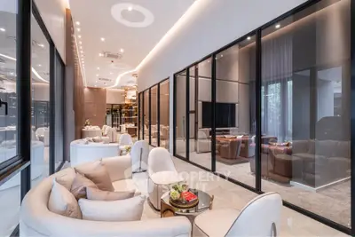 Luxurious modern living room with elegant furniture and glass partitions in a high-end apartment.