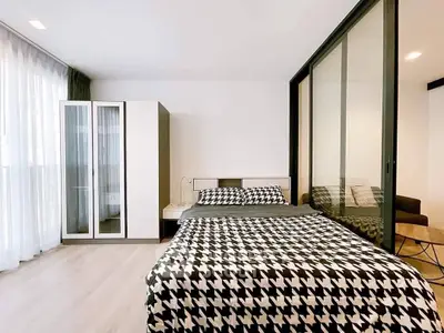 Modern bedroom with stylish decor and ample natural light