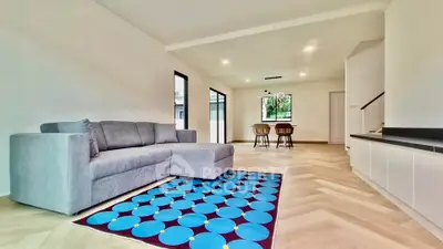 Spacious modern living room with stylish decor and large windows
