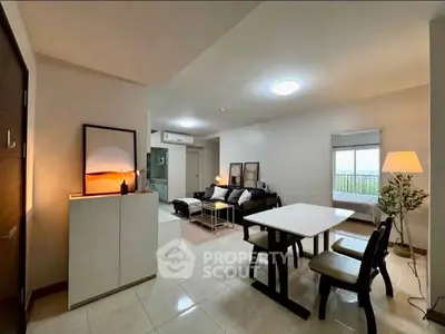 Modern open-plan living and dining area with stylish decor and natural lighting.