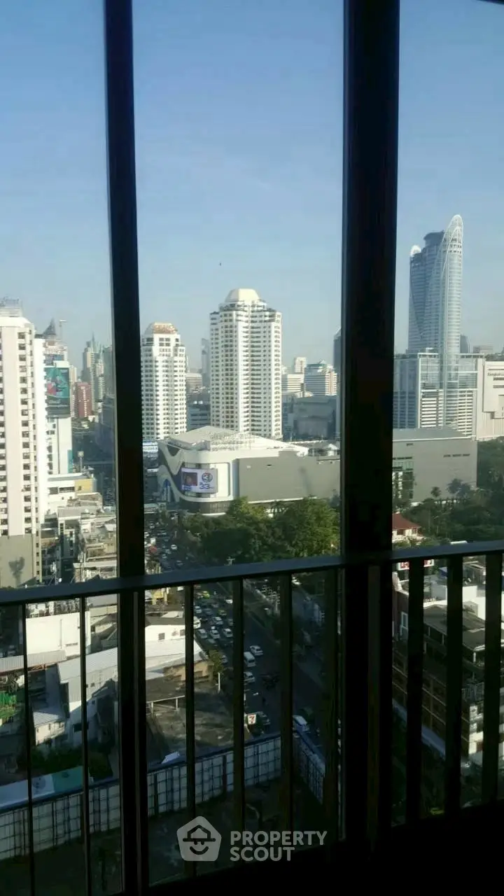 Stunning cityscape view from high-rise balcony with modern skyline.