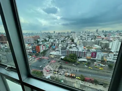 Stunning cityscape view from high-rise building window, showcasing vibrant urban life and skyline.