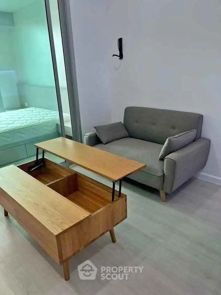 Modern living room with stylish sofa and innovative coffee table in a cozy apartment setting.