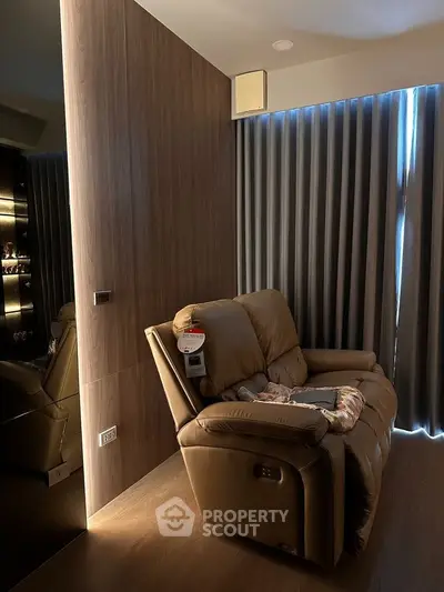 Cozy living room with plush recliner and elegant wood paneling