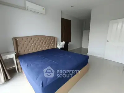 Spacious bedroom with modern furnishings and air conditioning