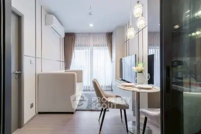Modern living room with dining area, stylish lighting, and large windows for natural light.