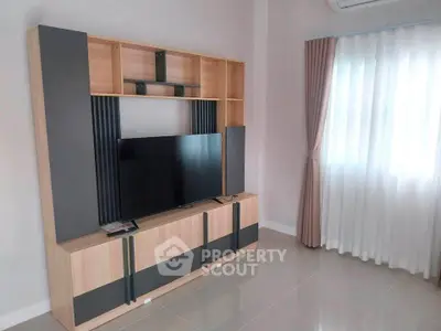 Modern living room with sleek TV stand and natural light