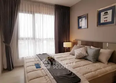 Cozy bedroom with elegant decor and large window for natural light