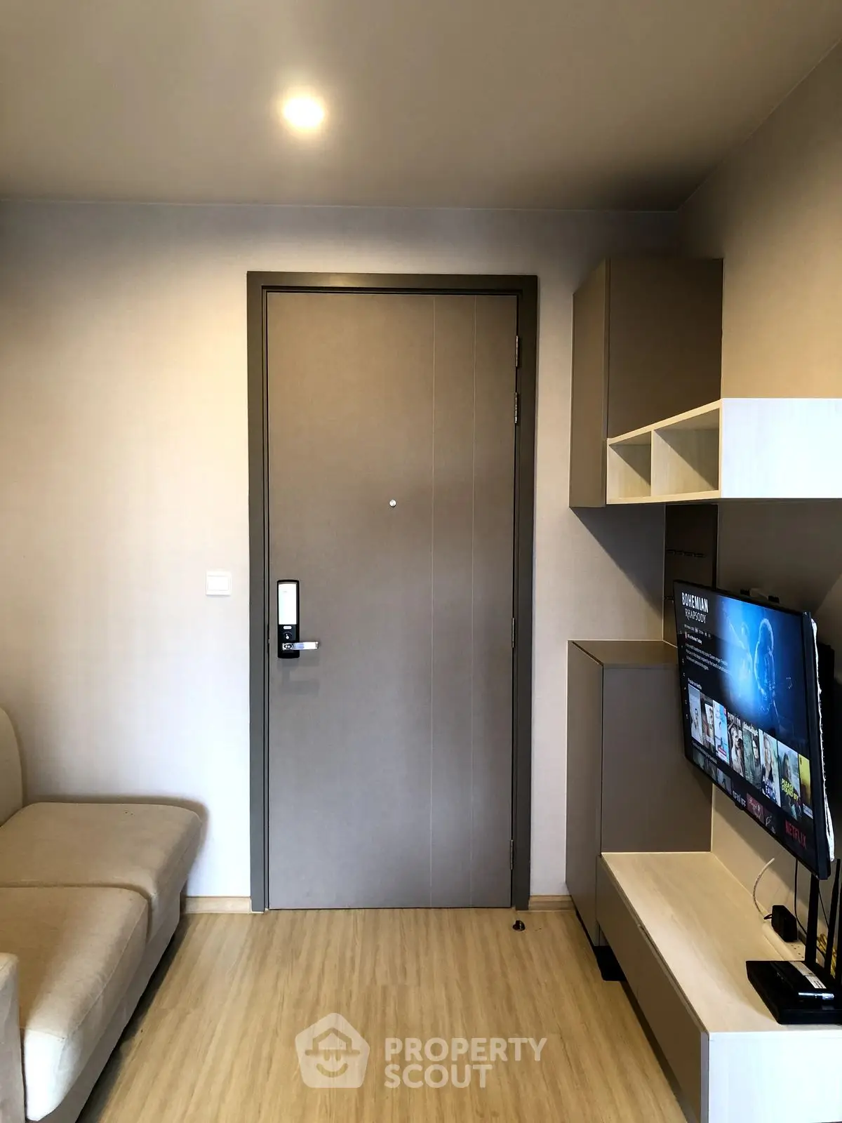 Modern living room with sleek furniture and wall-mounted TV, perfect for cozy relaxation.