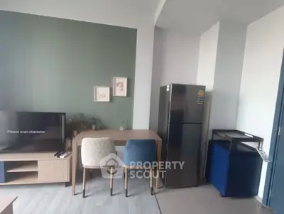 Modern living room with stylish furniture and sleek refrigerator, perfect for contemporary urban living.