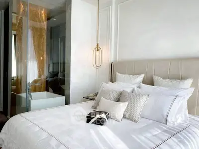 Luxurious bedroom with elegant decor and modern glass partition.