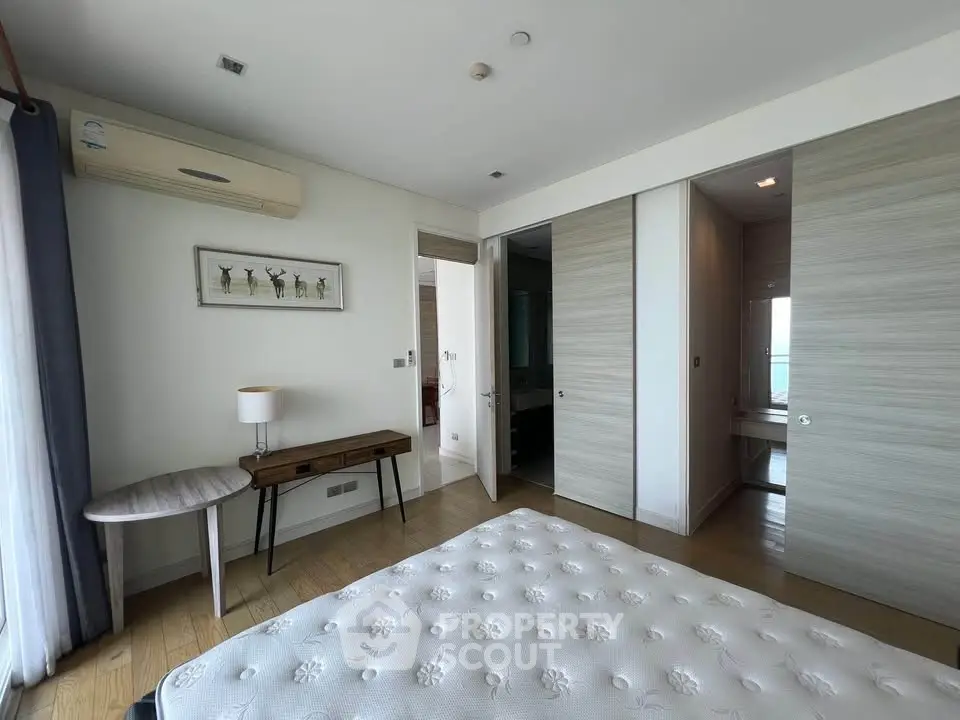 Spacious bedroom with modern decor and ample natural light