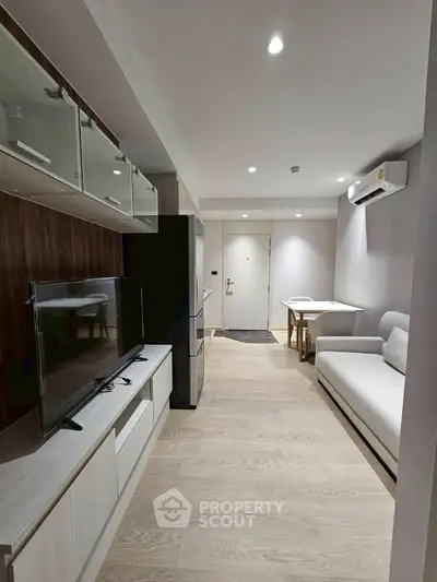 Modern living room with sleek furniture and open layout in a stylish apartment.