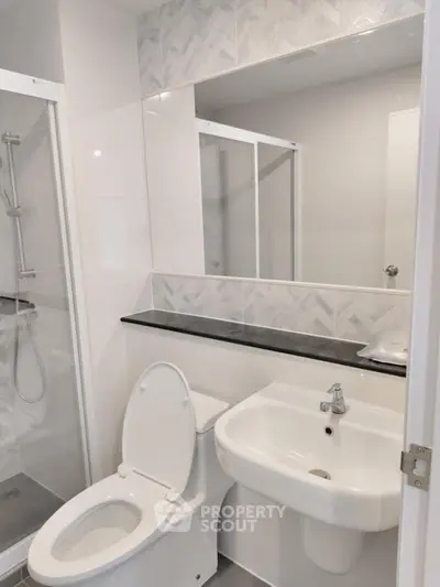 Modern bathroom with sleek fixtures and glass shower enclosure