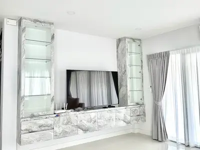 Modern living room with sleek marble entertainment center and large TV