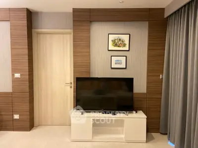 Modern living room with stylish wood paneling and sleek TV setup.