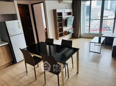 Modern open-plan living room with dining area and city view balcony, featuring sleek furniture and wooden flooring.