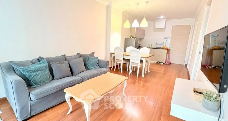 Spacious living room with elegant decor and open kitchen layout in modern apartment.