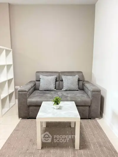 Cozy living room with modern gray sofa and chic white coffee table