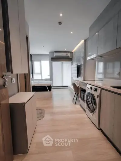 Modern apartment interior with sleek kitchen and cozy bedroom view