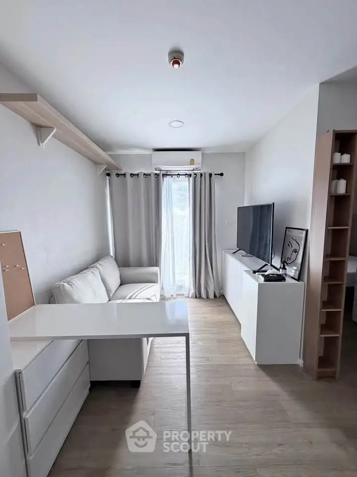 Modern living room with sleek furniture and natural light, perfect for urban living.