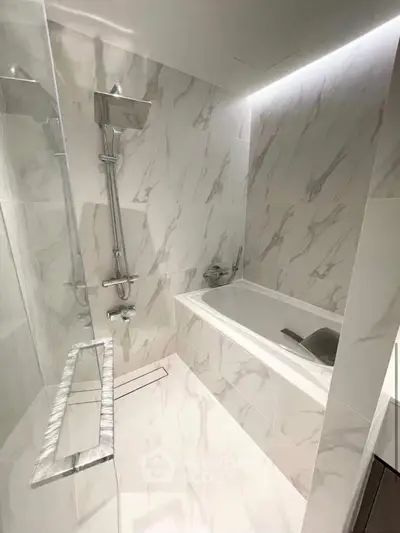 Luxurious marble bathroom with modern fixtures and elegant bathtub
